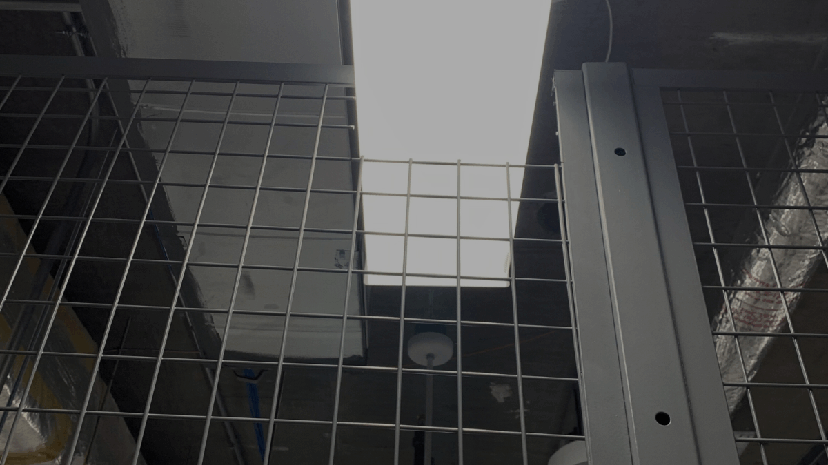 Wire mesh enclosure with field cut for lighting